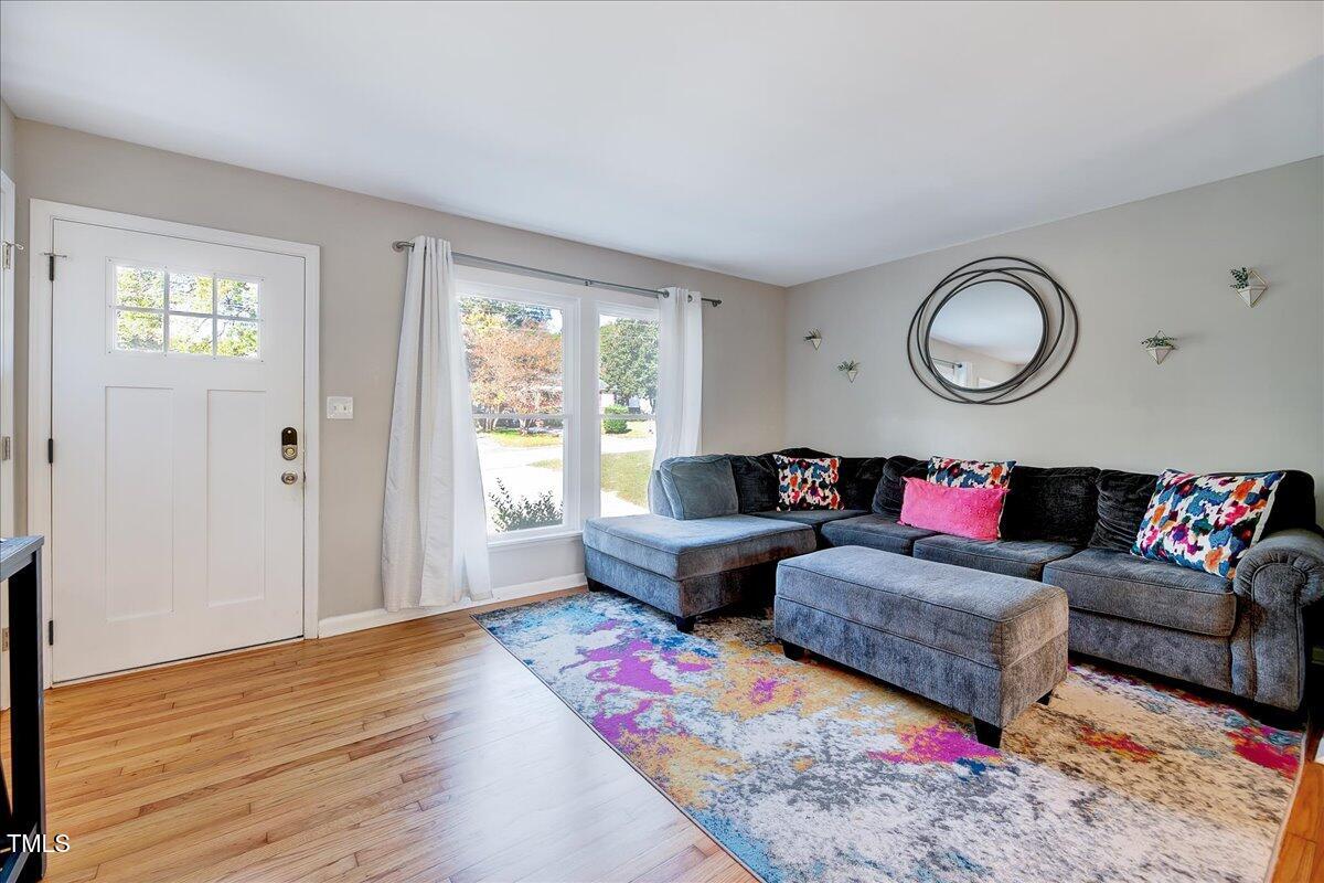 2809 Newark Drive Raleigh, NC 27610 - Photo 5 of 36 a living room with furniture and wooden floor