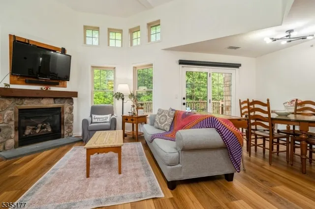a living room with furniture fireplace and flat screen tv