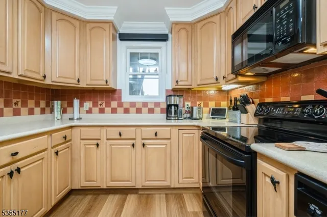 a kitchen with stainless steel appliances granite countertop a refrigerator and a stove
