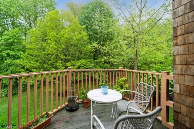 a view of a chair and table on the deck