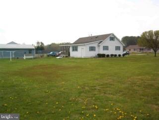 6323 Friendship Road Pittsville, MD 21850 - Photo 2 of 4 a front view of a house with a yard