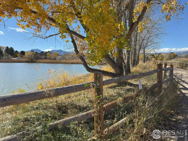 a view of a yard with wooden fence