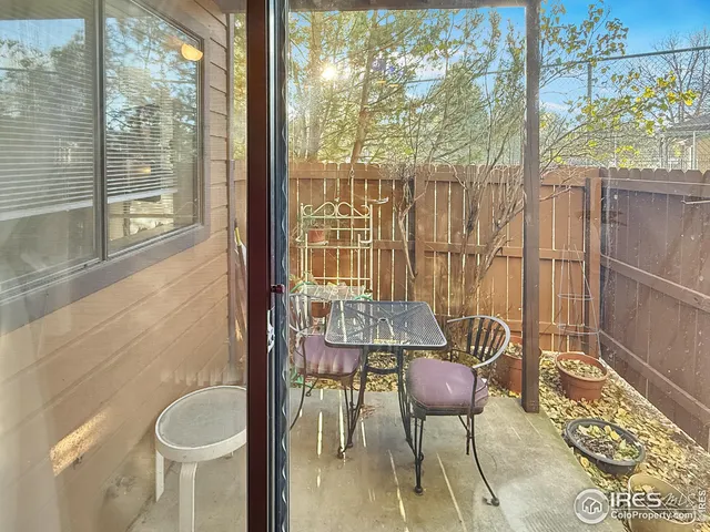 a balcony with table and chairs
