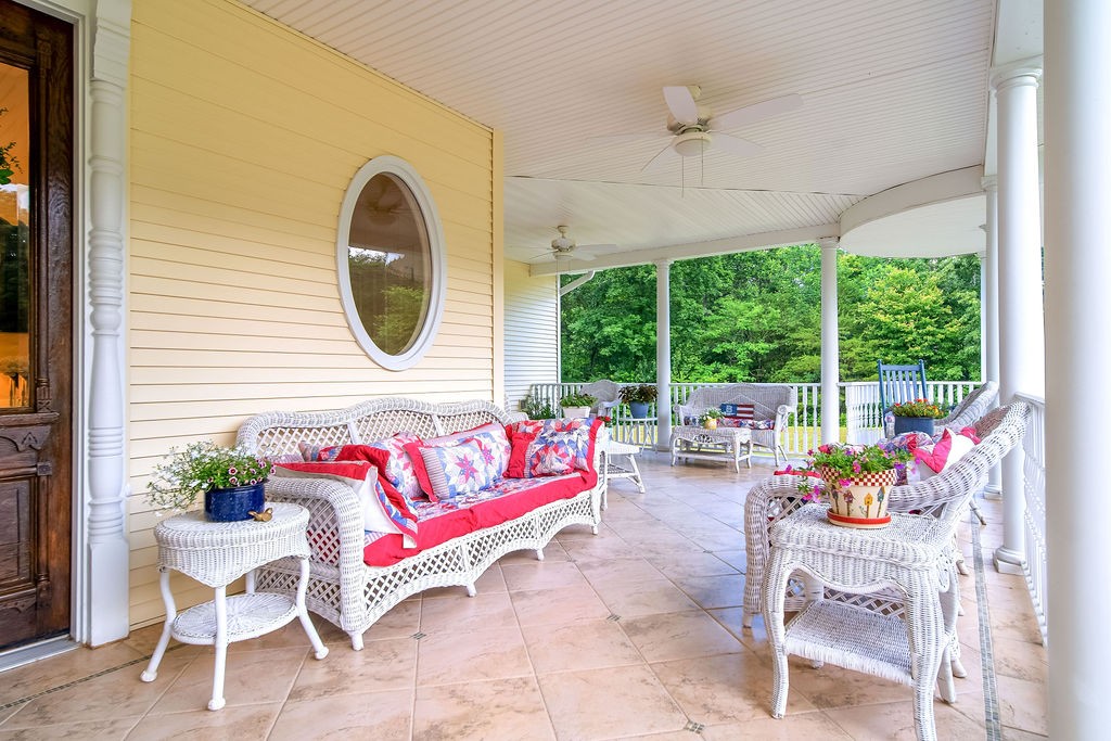 909 Williamson County Line Road Fairview, TN 37062 - Photo 16 of 66 a living room with patio furniture and a potted plant