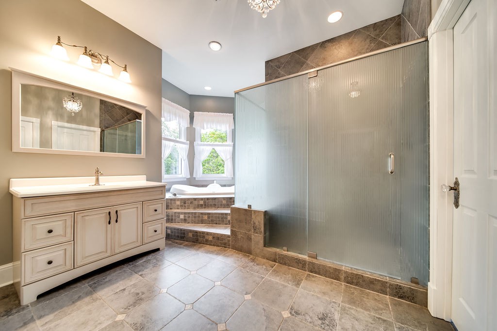 909 Williamson County Line Road Fairview, TN 37062 - Photo 27 of 66 a bathroom with a double vanity sink a toilet and shower