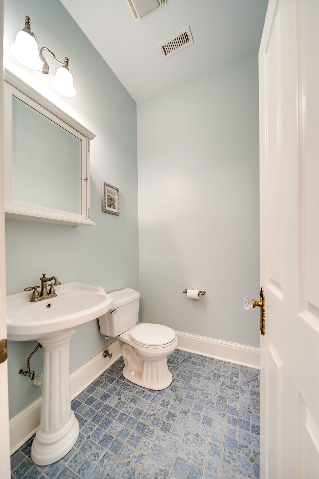 909 Williamson County Line Road Fairview, TN 37062 - Photo 34 of 66 a bathroom with a sink a toilet and mirror