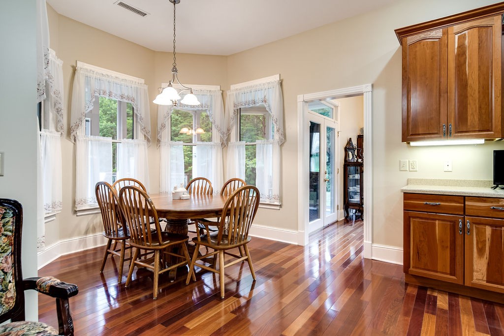 909 Williamson County Line Road Fairview, TN 37062 - Photo 35 of 66 a dining room with furniture a chandelier and wooden floor