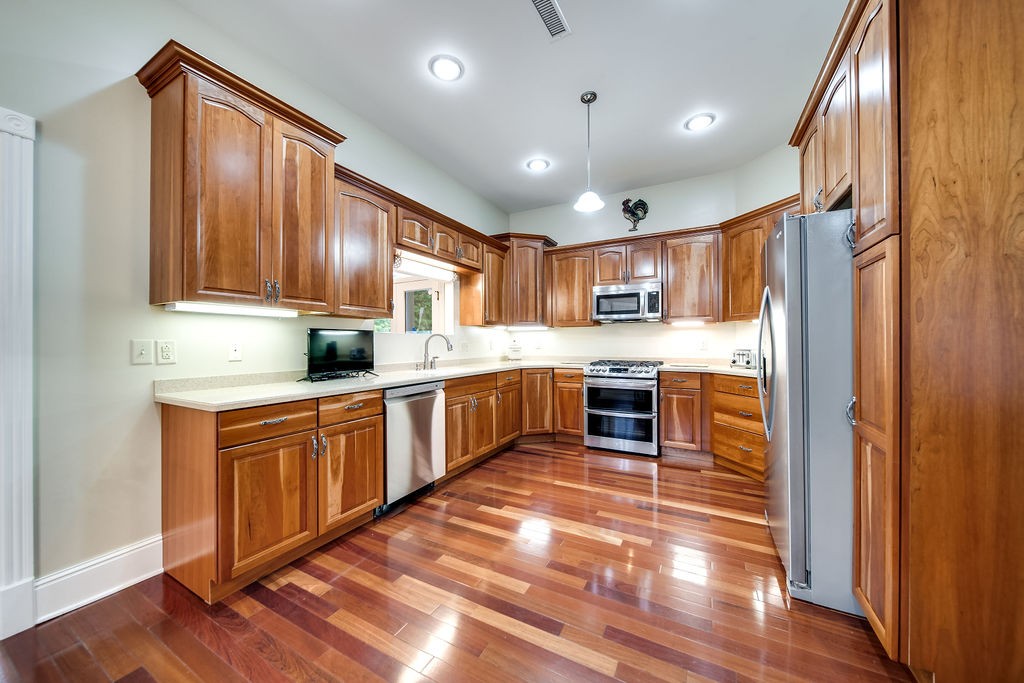 909 Williamson County Line Road Fairview, TN 37062 - Photo 37 of 66 a large kitchen with stainless steel appliances granite countertop a refrigerator and wooden cabinets