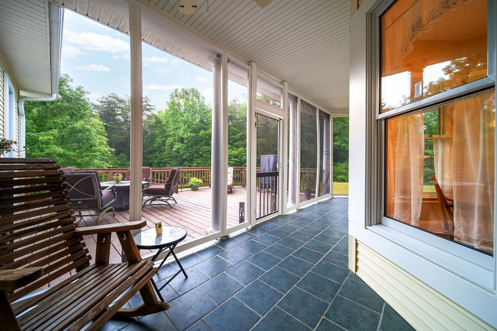 909 Williamson County Line Road Fairview, TN 37062 - Photo 53 of 66 a view of a patio with table and chairs and wooden floor
