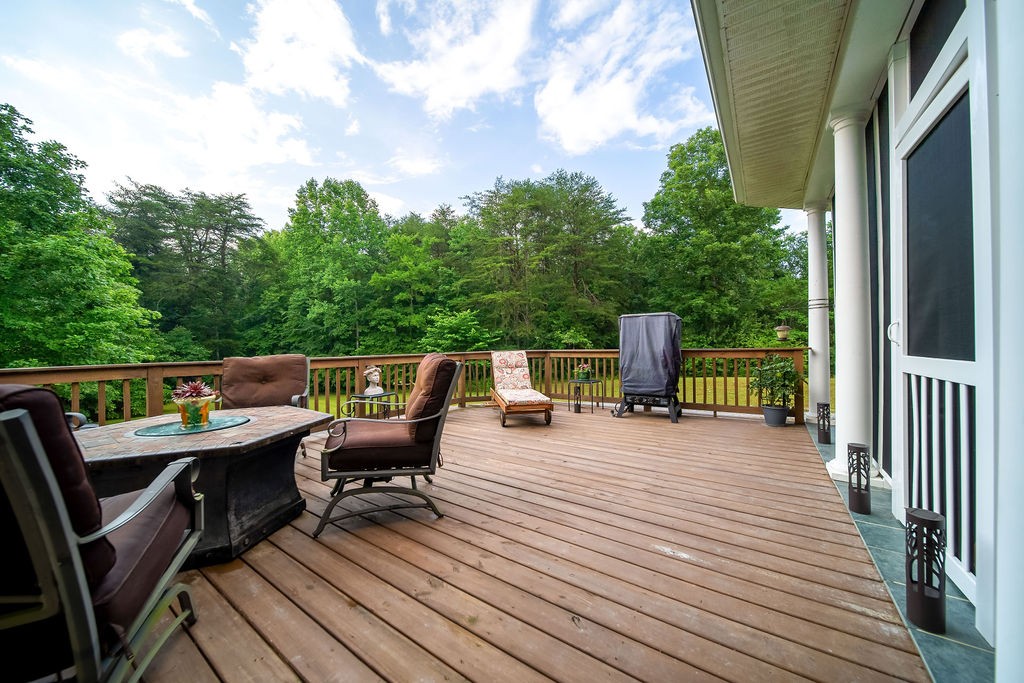 909 Williamson County Line Road Fairview, TN 37062 - Photo 55 of 66 a roof deck with chairs and wooden floor