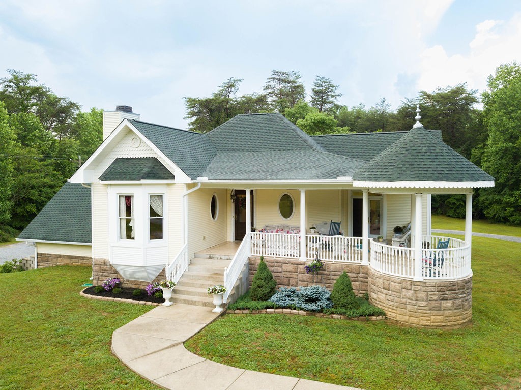 909 Williamson County Line Road Fairview, TN 37062 - Photo 6 of 66 a front view of a house with a yard table and chairs