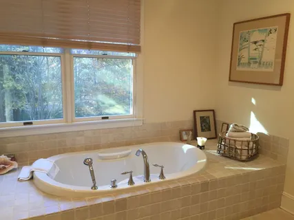 a bath tub sitting next to a window