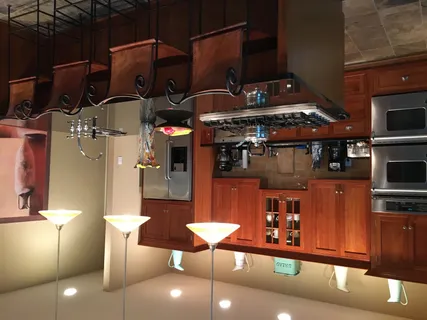 a kitchen with stainless steel appliances granite countertop a sink and a refrigerator