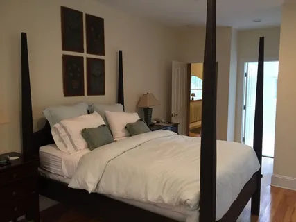 a bedroom with a large bed and a large window