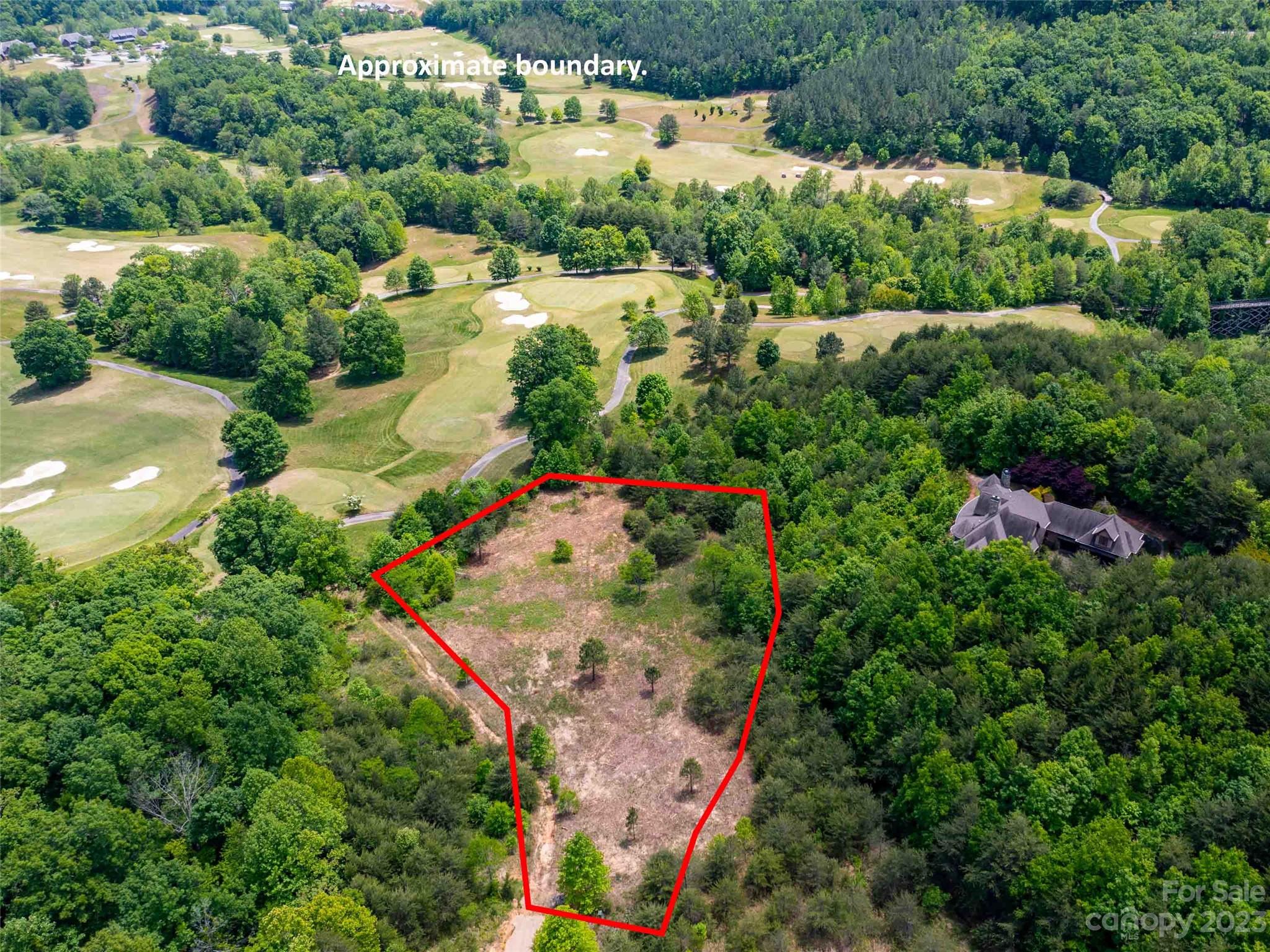 Lot 185 Harris Ct Mill Spring Mill Spring, NC 28756 - Photo 2 of 5 an aerial view of a house with a yard and lake view