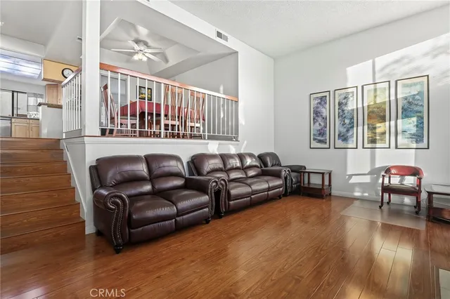 a living room with furniture and wooden floor
