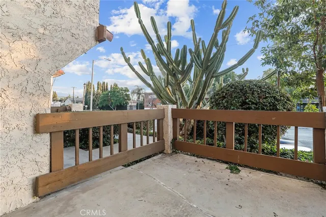 a balcony of a house with wooden floor and outdoor space