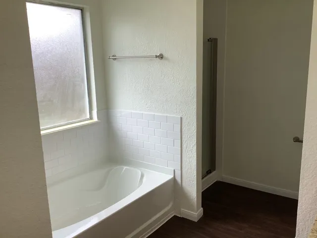 a bathroom with a bathtub and a shower