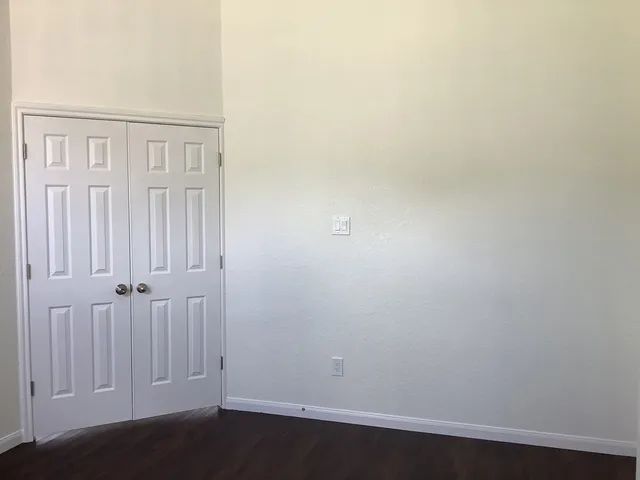 an empty room with wooden floor