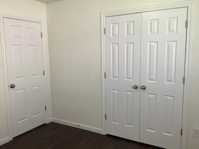 an empty room with wooden floor