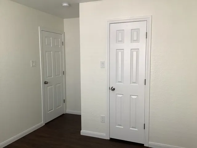 an empty room with wooden floor