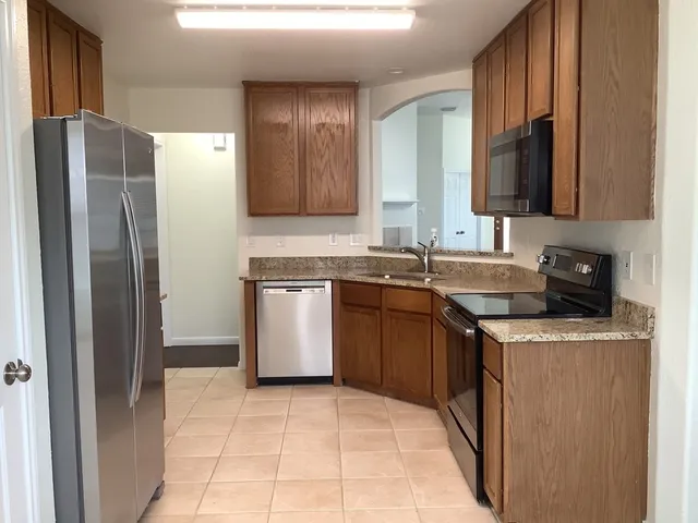 a kitchen with a sink stove and refrigerator