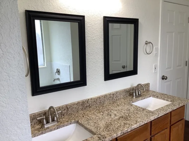 a bathroom with sinks and mirror