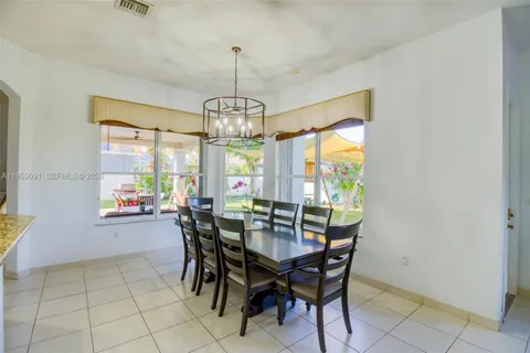 a living room with furniture kitchen view and a large window