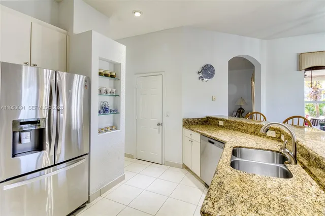 a kitchen with a refrigerator sink and stove