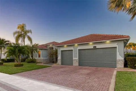 a front view of a house with a yard and a garage