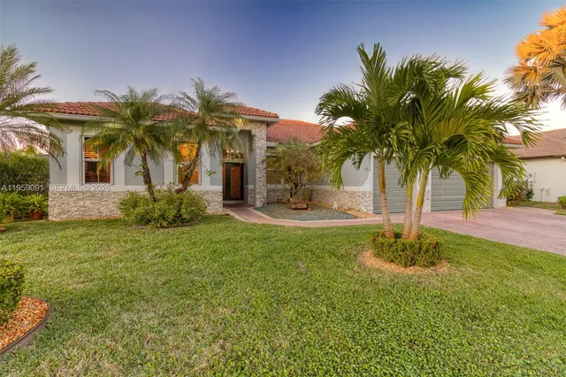 a palm tree sitting in front of a house with a big yard