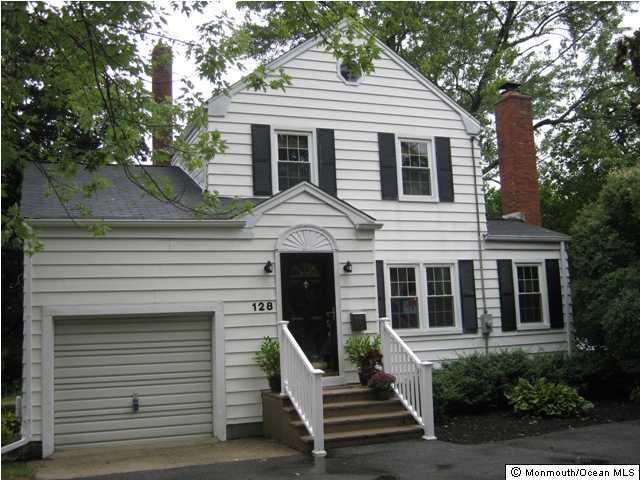 128 Ravine Drive Matawan, NJ 07747 - Photo 1 of 3 a front view of a house with a yard