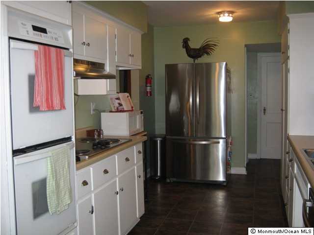 128 Ravine Drive Matawan, NJ 07747 - Photo 2 of 3 a kitchen with stainless steel appliances a refrigerator stove and sink