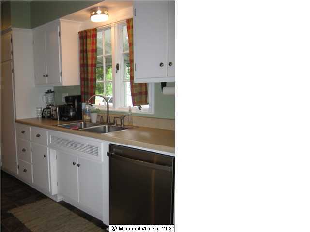 128 Ravine Drive Matawan, NJ 07747 - Photo 3 of 3 a bathroom with a sink and a mirror