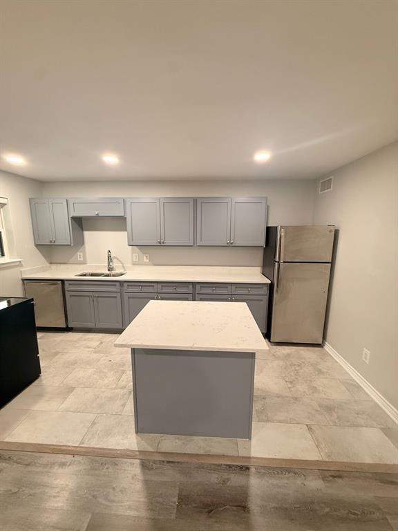 3933 Inwood Road, Unit 2025 Dallas, TX 75209 - Photo 4 of 26 a large kitchen with kitchen island granite countertop a sink and white cabinets