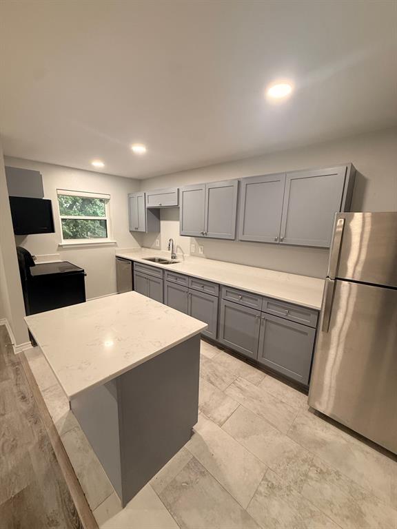3933 Inwood Road, Unit 2025 Dallas, TX 75209 - Photo 6 of 26 a kitchen with stainless steel appliances a refrigerator sink and cabinets