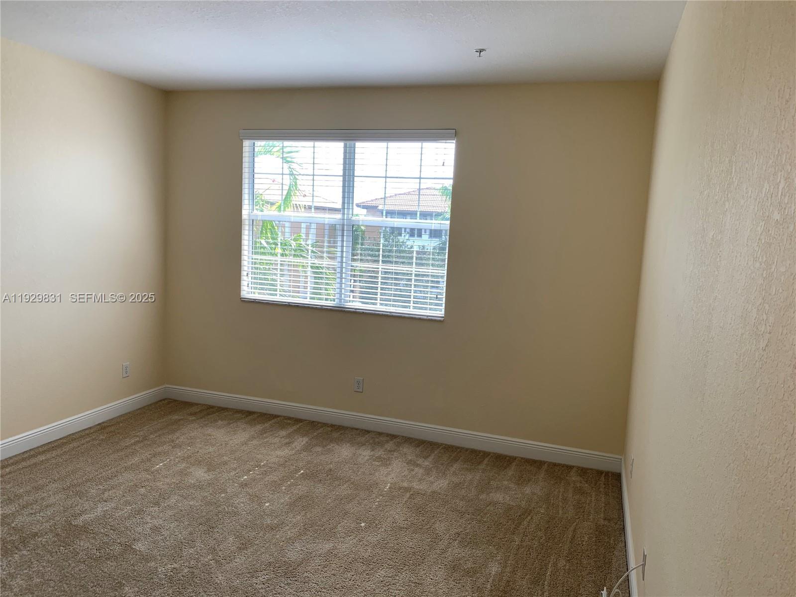 1044 Southwest 147th Avenue, Unit 10105 Pembroke Pines, FL 33027 - Photo 13 of 23 an empty room with a window