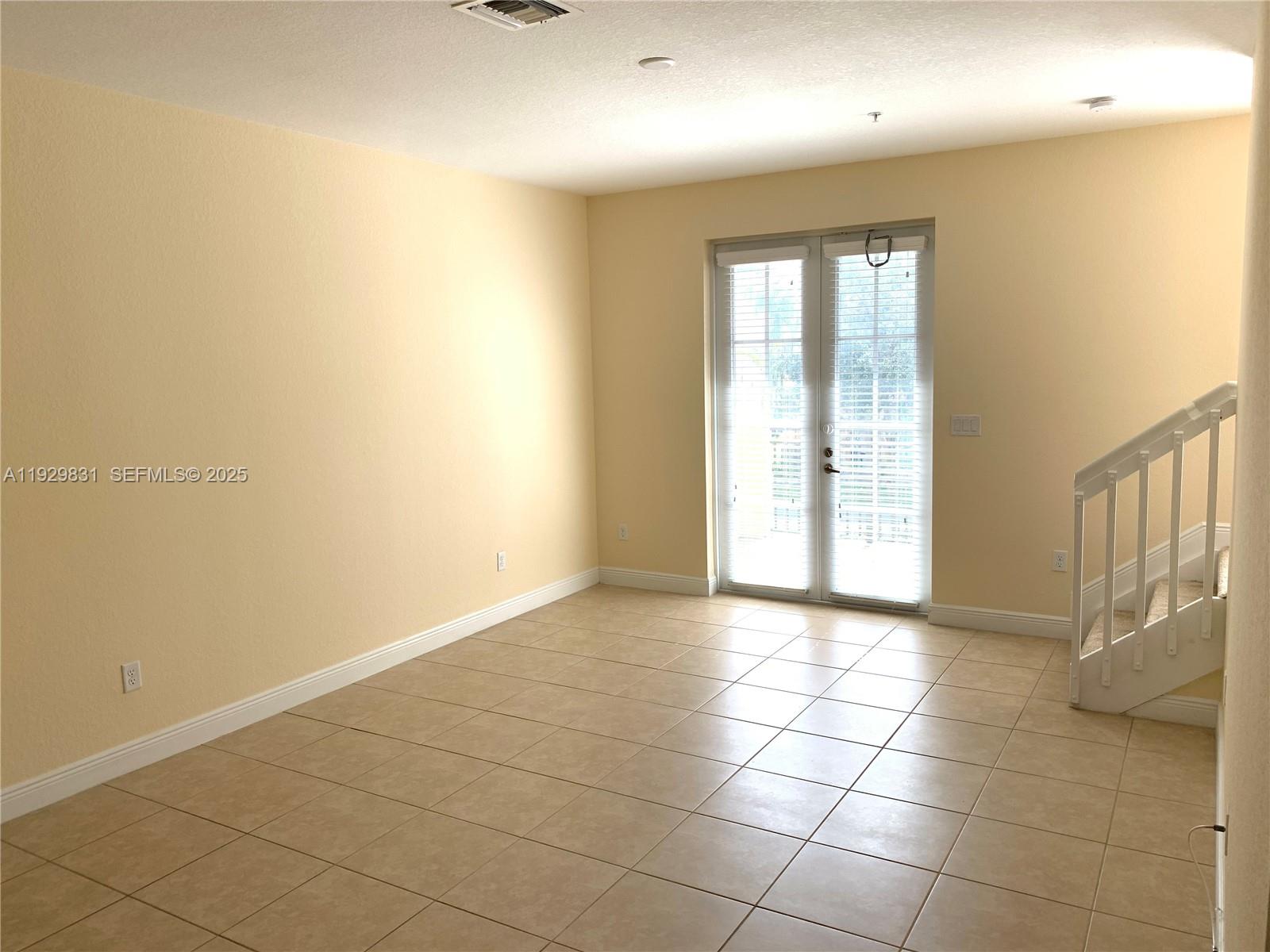 1044 Southwest 147th Avenue, Unit 10105 Pembroke Pines, FL 33027 - Photo 9 of 23 a view of an empty room and window