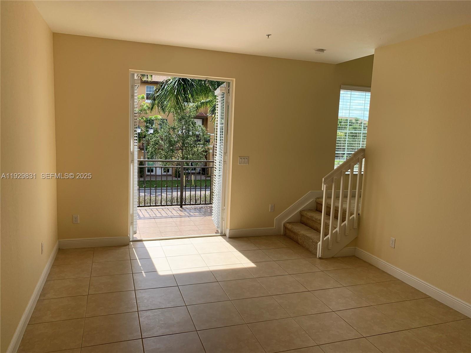 1044 Southwest 147th Avenue, Unit 10105 Pembroke Pines, FL 33027 - Photo 10 of 23 a view of an entryway with a floor to ceiling window