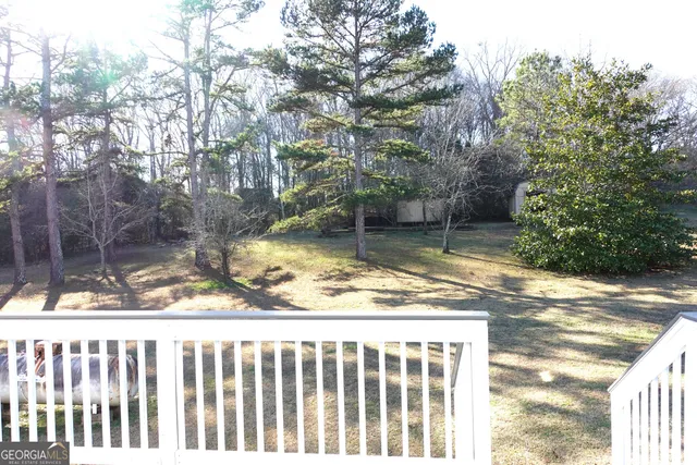 a backyard of a house with a yard and outdoor seating