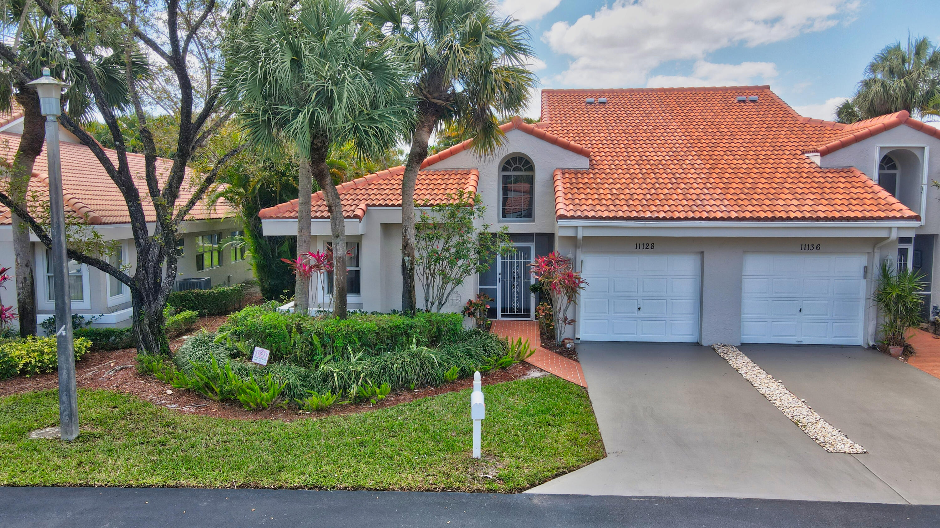 11128 Rios Road Boca Raton, FL 33498 - Photo 1 of 45 front view of a house with a garden