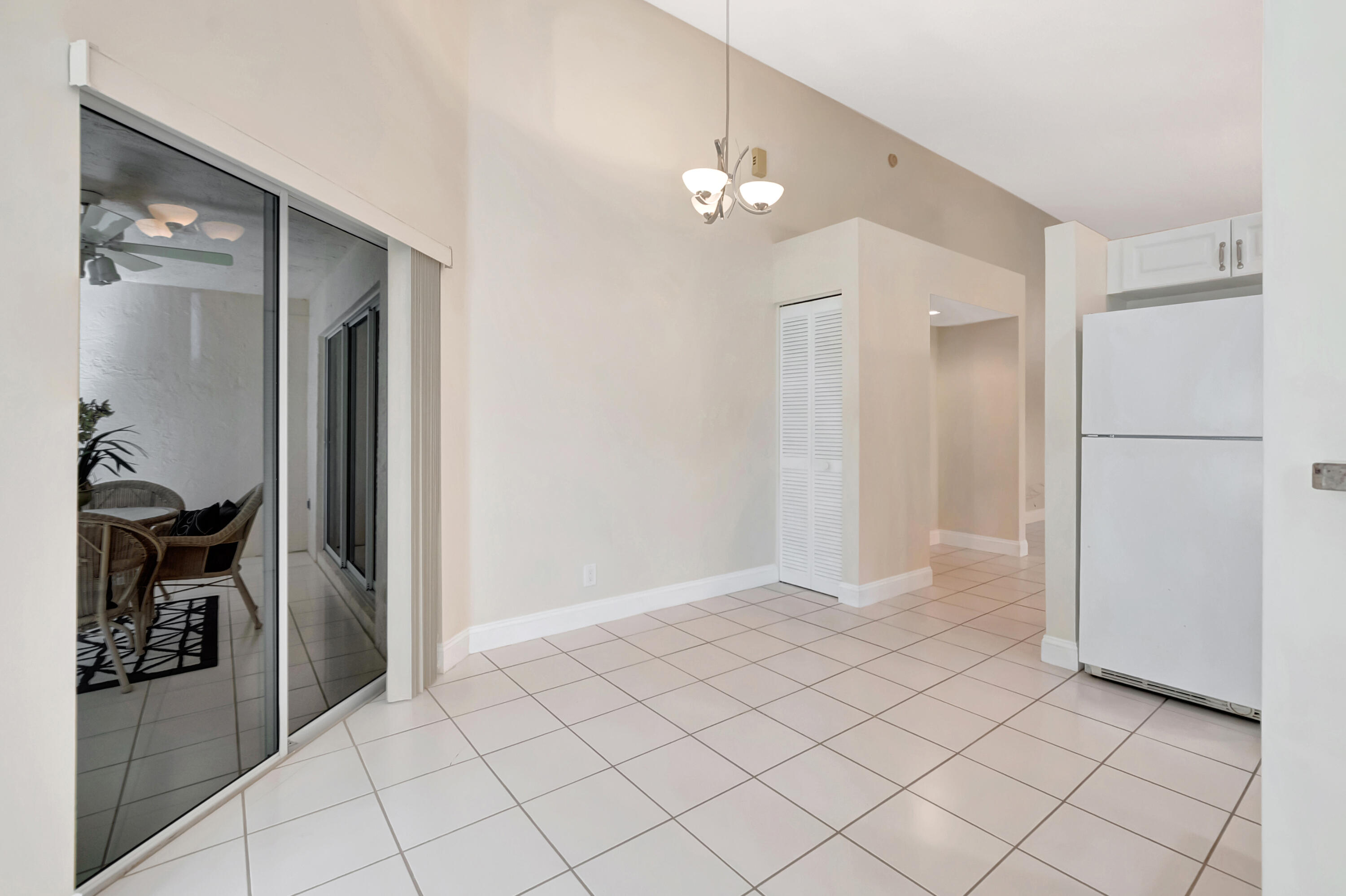 11128 Rios Road Boca Raton, FL 33498 - Photo 14 of 45 a view of a hallway with closet and a chandelier