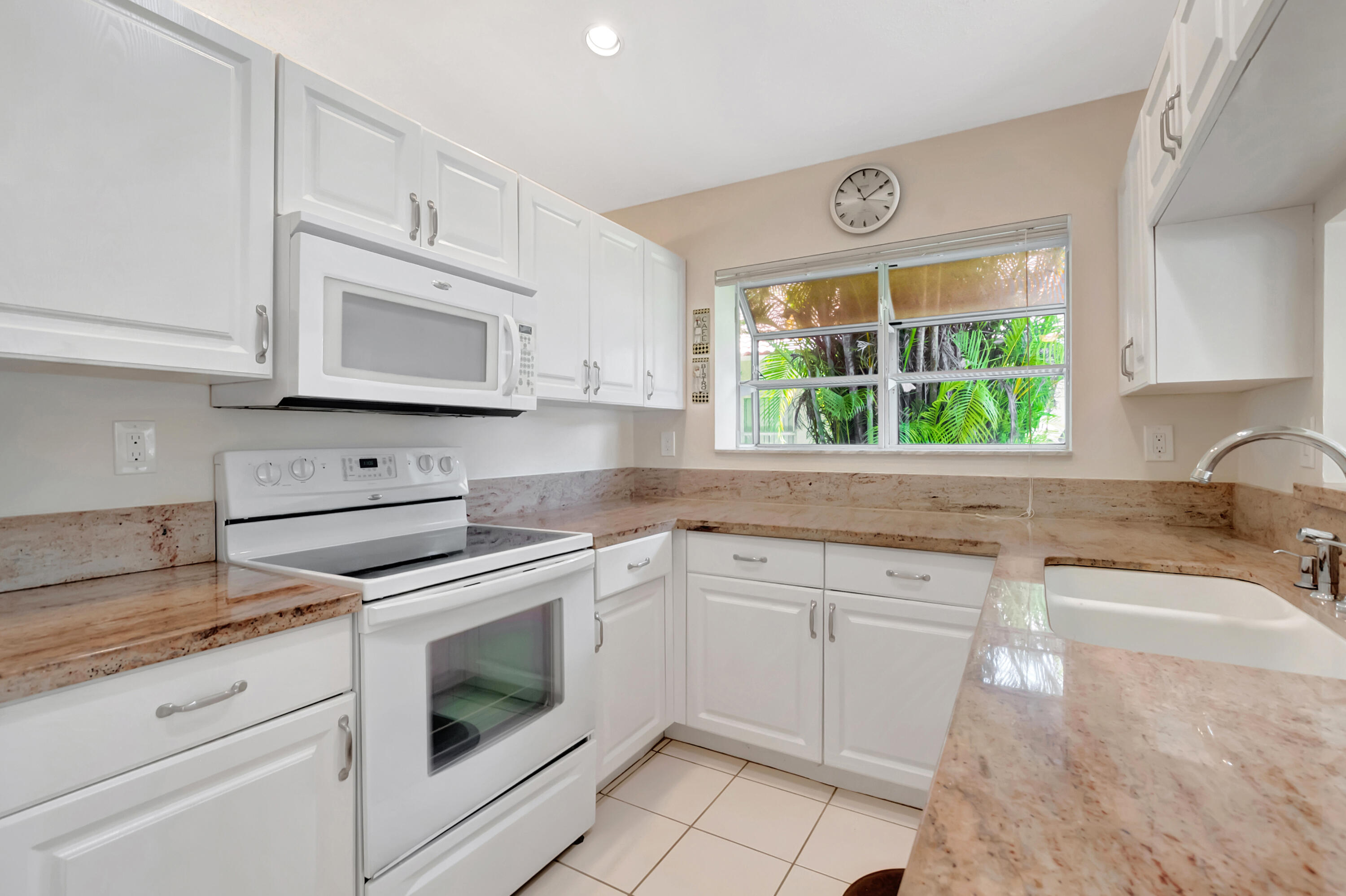 11128 Rios Road Boca Raton, FL 33498 - Photo 17 of 45 a kitchen with stainless steel appliances granite countertop white cabinets a stove a sink and a oven