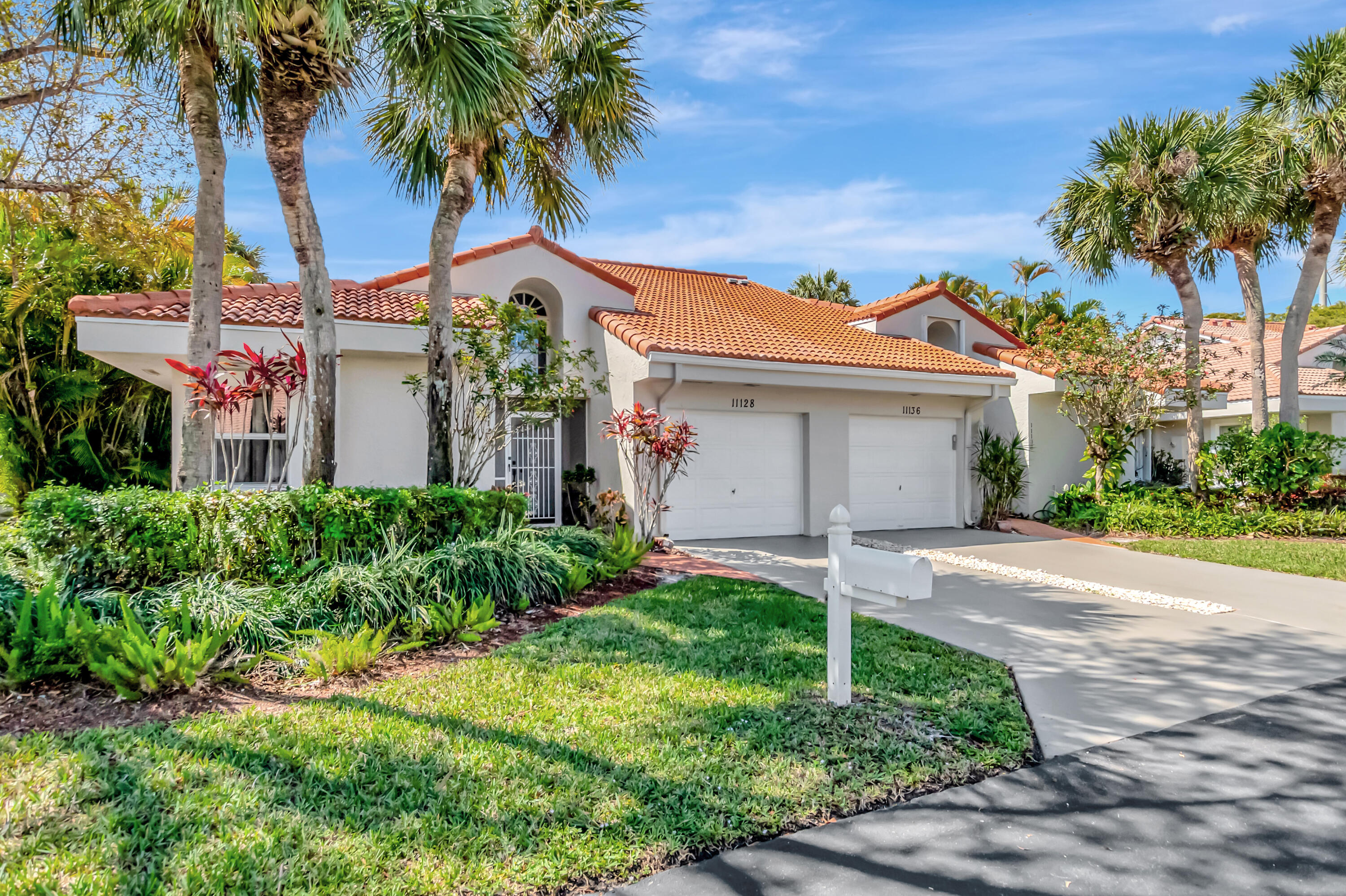 11128 Rios Road Boca Raton, FL 33498 - Photo 2 of 45 front view of a house with a yard