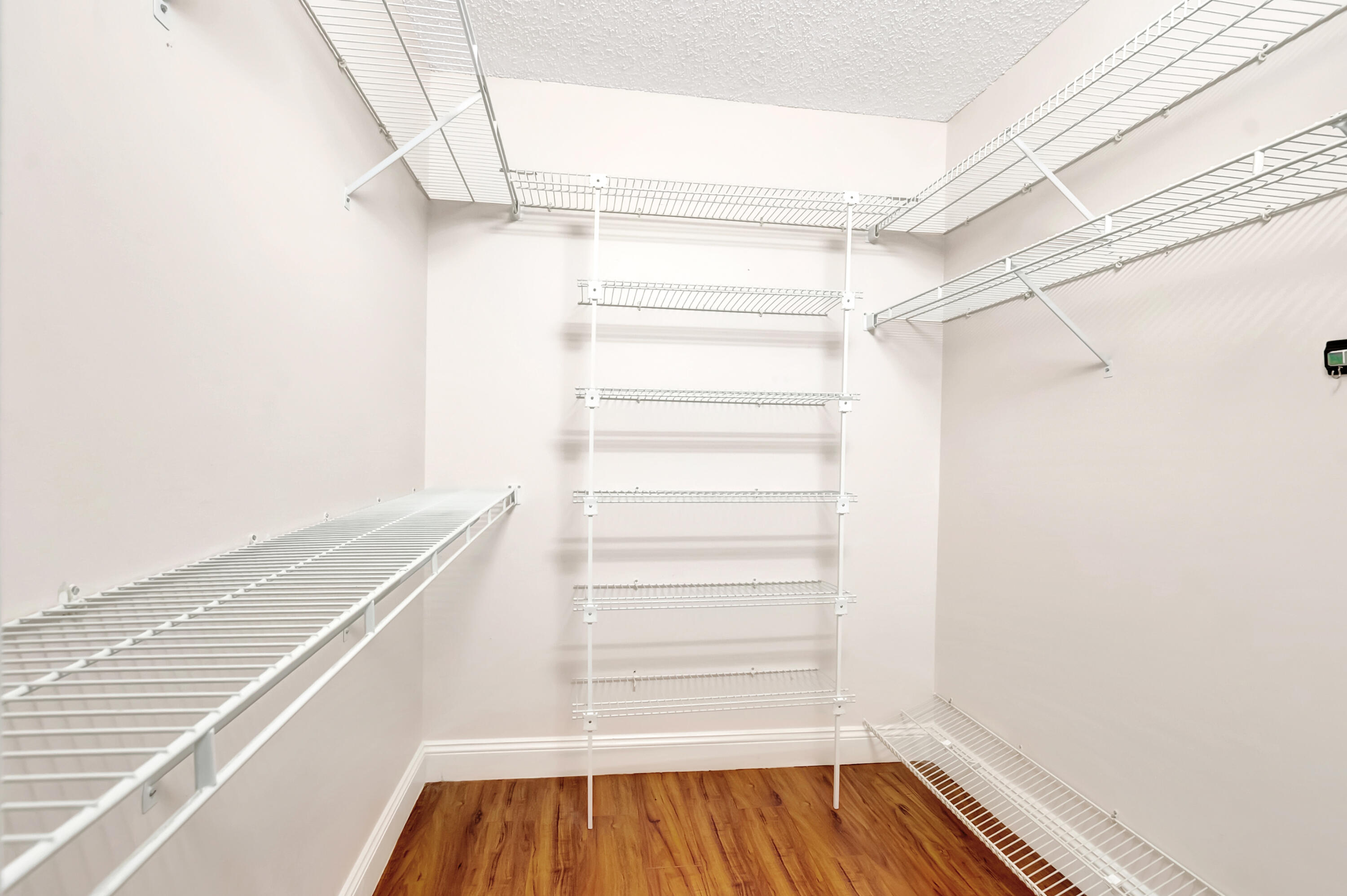 11128 Rios Road Boca Raton, FL 33498 - Photo 25 of 45 a view of walk in closet with empty racks
