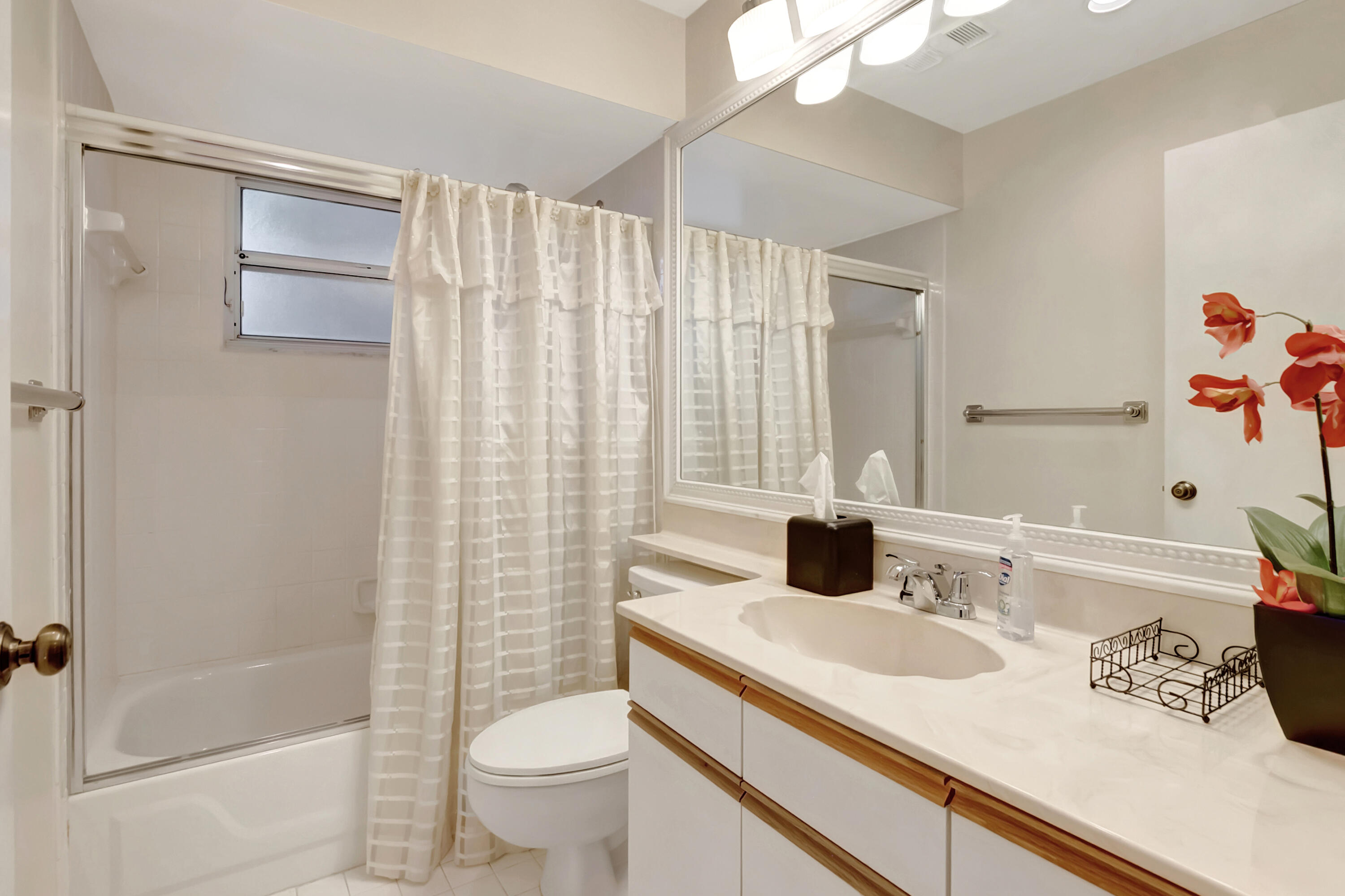11128 Rios Road Boca Raton, FL 33498 - Photo 28 of 45 a bathroom with a granite countertop sink a toilet and shower