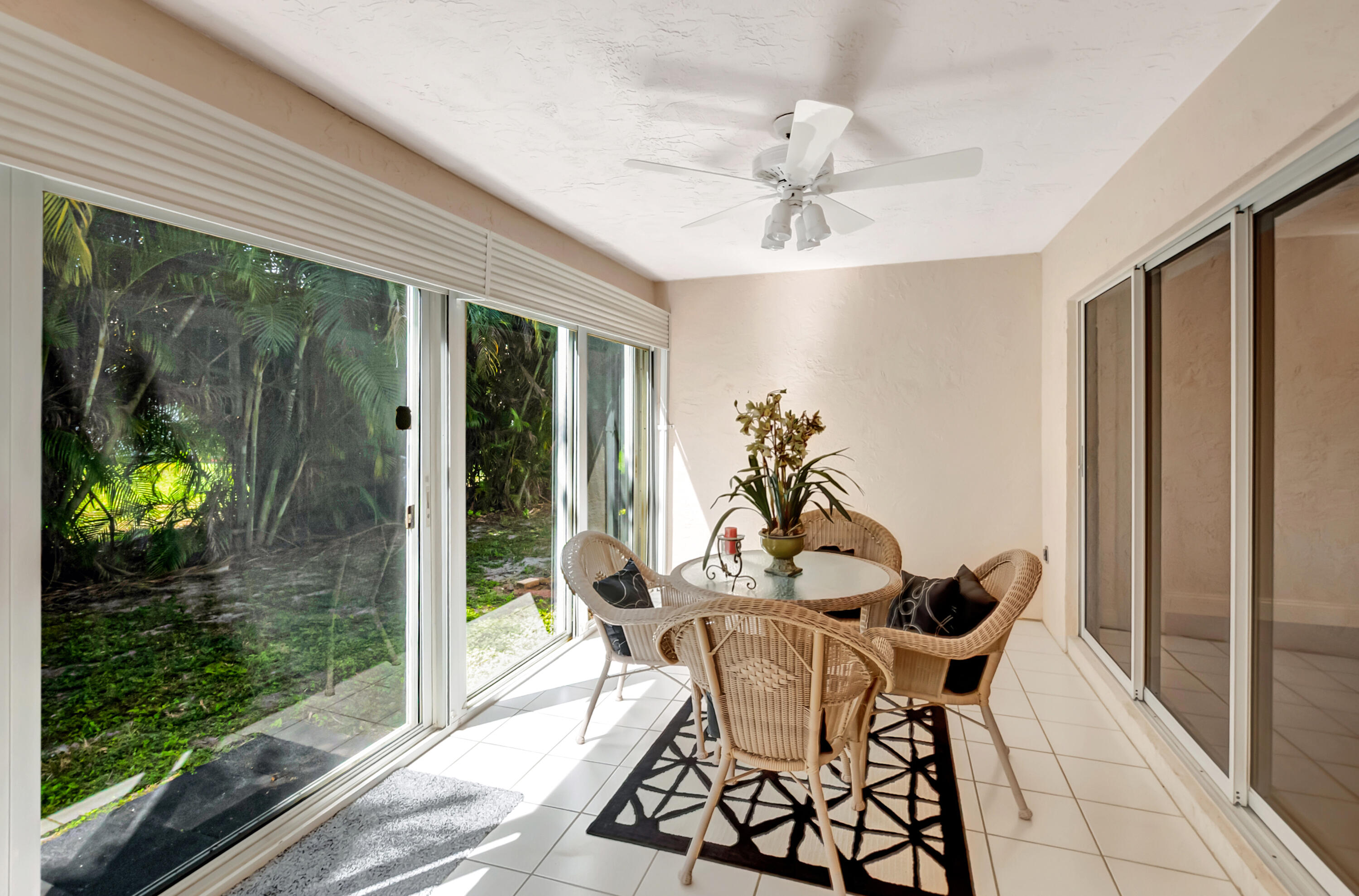 11128 Rios Road Boca Raton, FL 33498 - Photo 32 of 45 a dining room with furniture potted plants and wooden floor