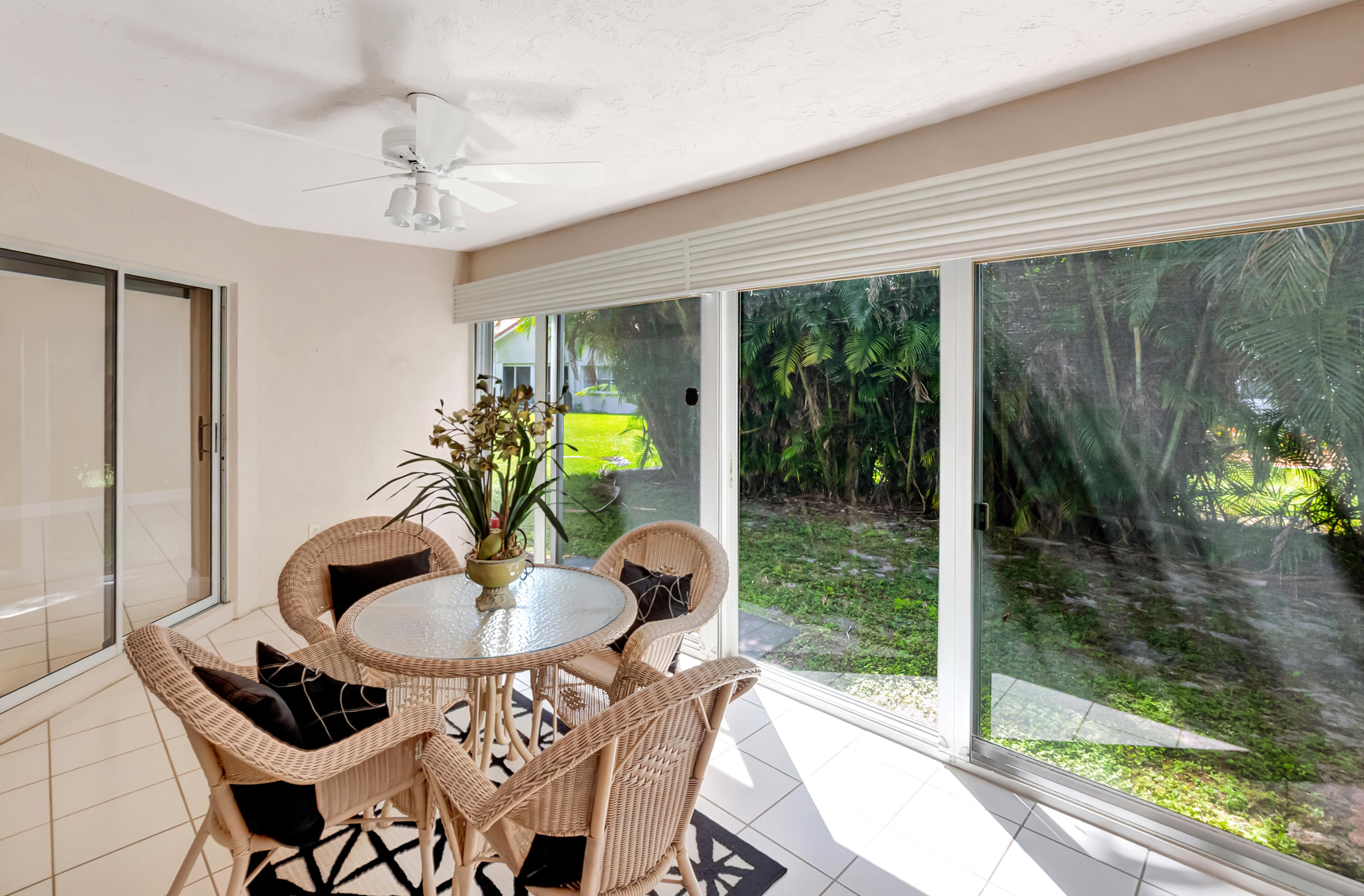 11128 Rios Road Boca Raton, FL 33498 - Photo 33 of 45 a dining room with furniture and a floor to ceiling window
