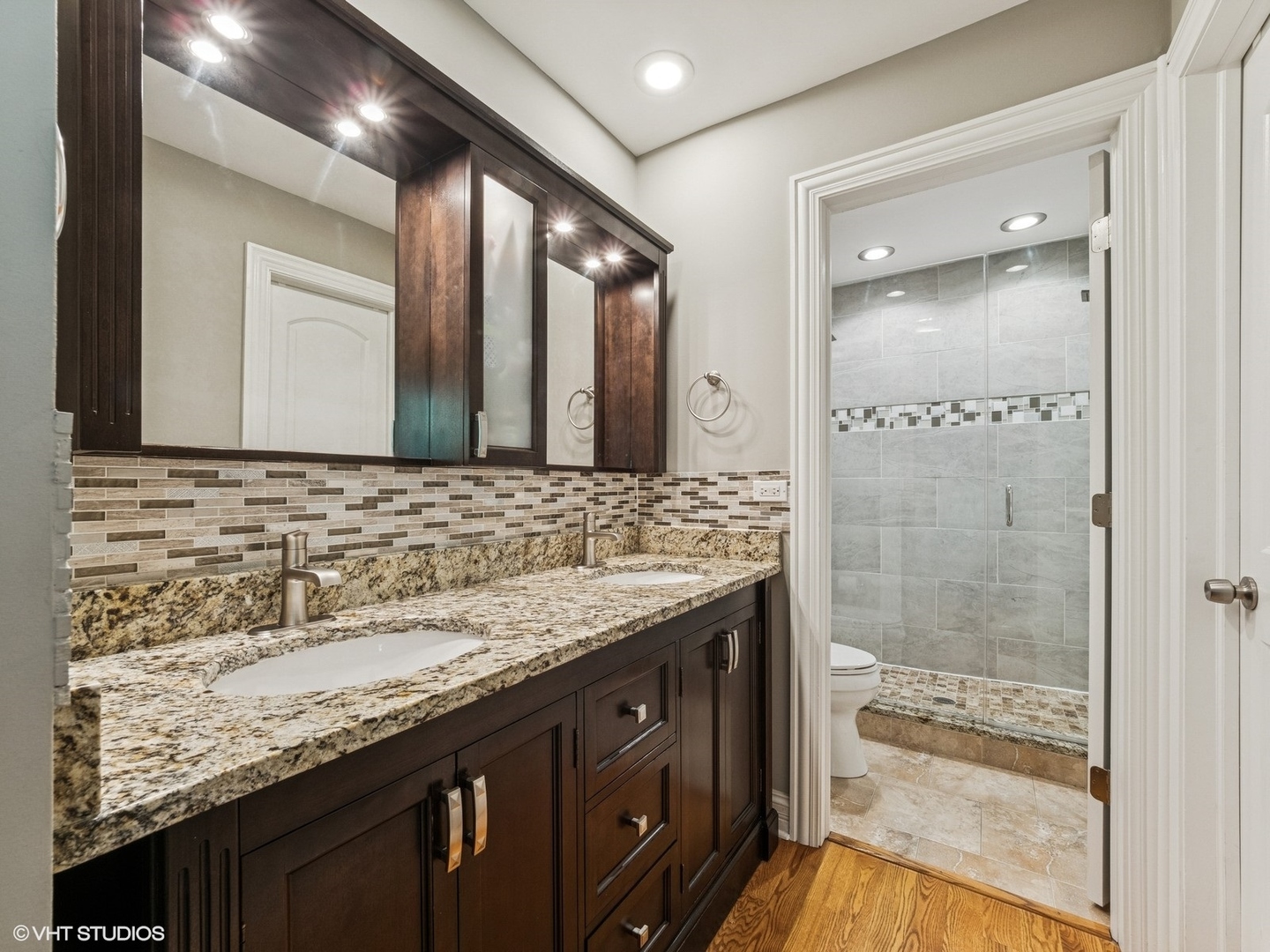 651 Garth Road Wheeling, IL 60090 - Photo 12 of 24 a bathroom with a granite countertop sink a mirror and a shower