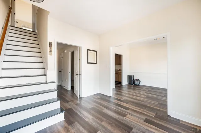a view of a room with wooden floor